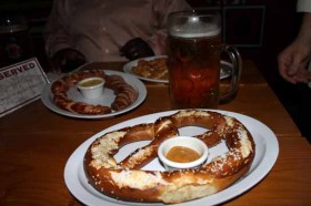 A feast of Oktoberfest goodies: pretzel, sausages, and of course - beer.