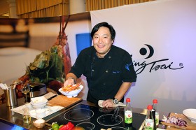 Chef Ming Tsai hands me a dish of his Sweet and Sour Pork on 2012-01-15 at Buick Food+Wine at St Regis Monarch, Dana Point 104