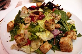 Fleming's signature salad: mixed greens, tomoatoes, onions, croutons, candided walnuts, and cranberries