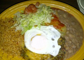 Stacked cheese enchiladas with a fried egg on top